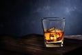 Glass of alcohol drink with ice on wooden table