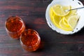 A glass of alcohol and sliced lemon. Royalty Free Stock Photo