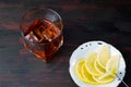 A glass of alcohol and sliced lemon. Royalty Free Stock Photo