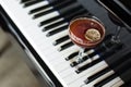 A glass of alcoholic cocktail on the background of a piano