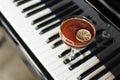 A glass of alcoholic cocktail on the background of a piano