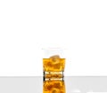 Glass with alcoholic drink with ice, on the rocks, whisky, rum, cognac, brandy, scottish, white background Royalty Free Stock Photo