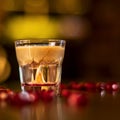 Glass with alkohol shot on wooden table Royalty Free Stock Photo