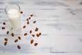 Glass of almond milk and copy space. Nuts on white wooden background. Nuts milk on a kitchen table Royalty Free Stock Photo