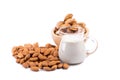 Glass of Almond milk with a heap of almonds on white background