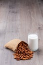 glass of Almond milk in a glass with Almond seeds. an wooden background Royalty Free Stock Photo