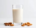 Glass of almond milk surrounded by almonds on white background. Generative AI Royalty Free Stock Photo