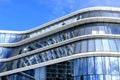 Glass and aluminum office building detail with reflective curtain wall panels