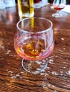 A glass of amaretto with soft background on a wooden table