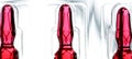 Glass ampoule with red liquid medicine