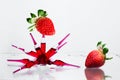 Glass ampoules with a red medicine vitamine b12 glued together with two strawberries