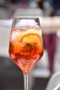 A glass of aperol sprits in outdoor cafe