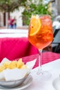 Glass of aperol spritz cocktail on outside table on sunny day Royalty Free Stock Photo