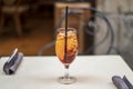 Glass of Aperol Spritz cocktail on the table in a terrace of restaurant Royalty Free Stock Photo