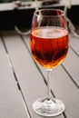 Glass of Aperol Spritz cocktail. Wineglass with rose wine. Sidewalk cafe table. Alcohol party. Orange color cocktails. Royalty Free Stock Photo