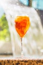 Glass of aperol spritz and negroni cocktail on stone edge of swimming pool. Royalty Free Stock Photo