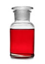 Glass apothecary bottle with red liquid sample isolated. Laboratory analysis