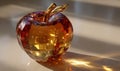 A glass apple with a gold stem and a red leaf Royalty Free Stock Photo