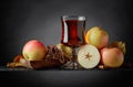 Glass of apple juice or cider with juicy apples and cinnamon sticks. Royalty Free Stock Photo