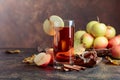 Glass of apple juice or cider with juicy apples and cinnamon sticks. Royalty Free Stock Photo