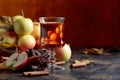 Glass of apple juice or cider with juicy apples and cinnamon sticks. Royalty Free Stock Photo