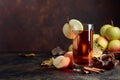 Glass of apple juice or cider with juicy apples and cinnamon sticks. Royalty Free Stock Photo