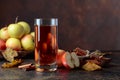 Glass of apple juice or cider with juicy apples and cinnamon sticks Royalty Free Stock Photo