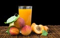 Glass apricot juice and fruits black isolated.
