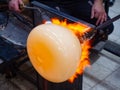 Glass artist forms the scorching glass with heats it with a gas burner Royalty Free Stock Photo