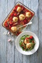 Oven baked meat balls with tomato sauce served with fresh zucchini salad