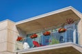 Glass balconies of modern apartment building in residential area. Balcony of modern condo with plants on sunny day Royalty Free Stock Photo