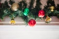 glass ball and decorations on Christmas tree.Garland with lights and red-green, gold balls on a white background Royalty Free Stock Photo