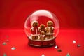 Glass ball with gingerbread cookies inside on red background Royalty Free Stock Photo