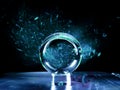 Glass ball on a metal surface and cold blue color light painting in the background. Abstract art with reflection and bald rich Royalty Free Stock Photo