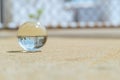 A glass ball is placed on the ground in the sunlight Royalty Free Stock Photo