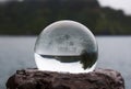 Glass Ball Tucked into Rusted Iron Captures Seascape with Palm T Royalty Free Stock Photo