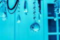 Glass balls on a metal chain. Decorating a chandelier with crystal pendant products. Tinted photo. Cold shades