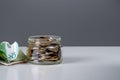 Glass bank for tips with money. Savings concept: coins in jar with copy space for text on dark gray background. Saving money Royalty Free Stock Photo