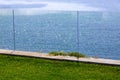 Glass barrier of a green lawn.