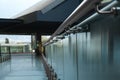 Glass barrier with metal handrail in modern building, closeup