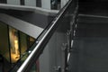 Glass barrier with metal handrail in modern building, closeup