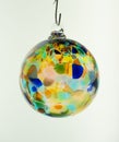 Glass bauble.  Single hand blown glass Christmas tree ornament in clear translucent multicolour Royalty Free Stock Photo