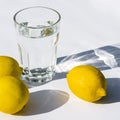 Water glass with strong shadows on white background