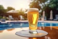 Glass of beer on the background of the pool and palms. Royalty Free Stock Photo