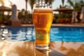 Glass of beer on the background of the pool and palms. Royalty Free Stock Photo