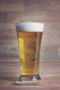 Glass beer and bale on wood background Royalty Free Stock Photo