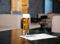 Glass of beer on bar counter Royalty Free Stock Photo