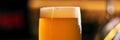 Glass of beer on bar table closeup Royalty Free Stock Photo