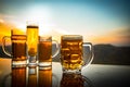 Glass of beer on a beach at sunset. Cooling summer drink concept. Close Up of A Glass of Draught Beer with the Bokeh of Sunlight Royalty Free Stock Photo