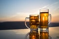 Glass of beer on a beach at sunset. Cooling summer drink concept. Close Up of A Glass of Draught Beer with the Bokeh of Sunlight Royalty Free Stock Photo